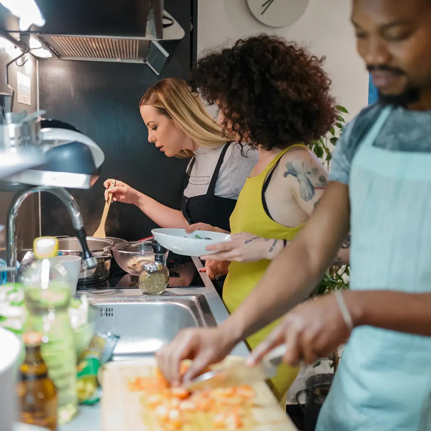 Residents cooking together in a kitchen, preparing meals as a community